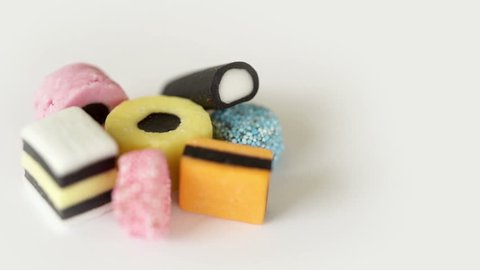 Camera move round a heap of liquorice sweets.
Camera slowly orbits around a pile of various liquorice sweets then stops.
