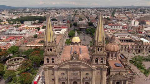 Aerial Through Neo-gothic Spires Of Guadalajara Cathedral Towards Plaza de la Liberacion In Guadalajara, Mexico.