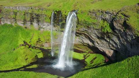 Powerful Water Of Seljalandsfoss Waterfall Flowing Into The River On A Sunny Summer Day In Iceland. - aerial approach