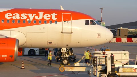 Bergamo , Italy - 09 12 2021: Ground Crews Servicing An Aircraft Of EasyJet Airline Parked At The Terminal Gate Of Bergamo Airport