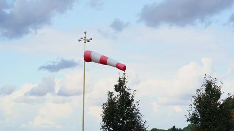 red and white flag. Wind designator - a device to indicate the direction of the wind on helipads, airfields, oil and gas producing enterprises, ranges and shooting ranges.