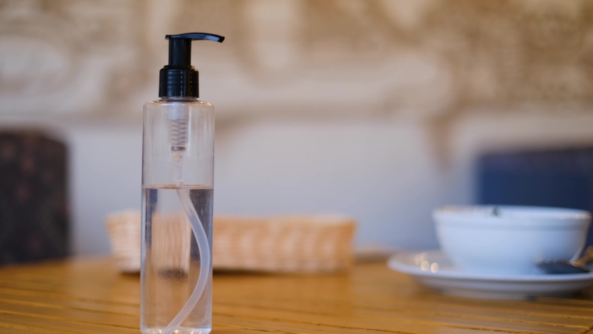 a man disinfects his hands with a sanitizer before eating. close-up