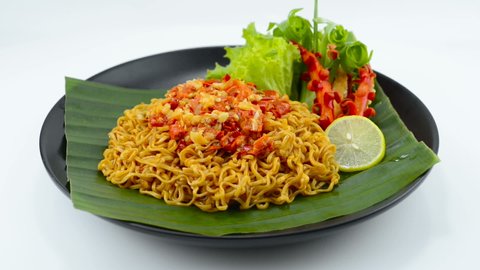Spicy Instant Noodles with Hot Chili Sambal Sauce Popular in Indonesia, Malaysia and Singapore decoration Carved Vegetable sideview