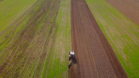 Tractor ploughing field. Polish aerial landscape with tractor.