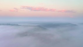 Drone flying over a thick morning fog that covered the agricultural lands. Cinematic aerial shot. Location Dniester river, Ukraine, Europe. Discover the beauty of earth. Filmed in 4k, drone video.