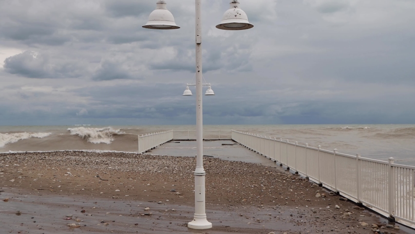 Waves crash upon a pier at Glencoe Beach near Chicago on a windy, fall day along Lake Michigan.