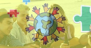 Animation of colourful puzzle pieces and globe with hands over happy friends at summer beach party. autism, learning difficulties, support and awareness concept digitally generated video.