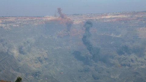 A controlled explosion in a quarry. Iron ore mining process. Big explosion in an iron ore quarry.