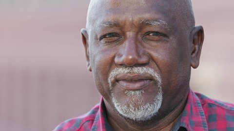 Headshot portrait of citizen serious pensive black male with wrinkles looking at camera closeup, friendly grandfather posing, gray-haired african american man feeling good, mature senior 