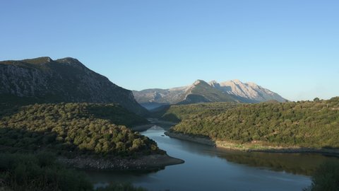 View from above, stunning aerial view of the Cedrino Lake - Lago del Cedrino, surrounded by the mountain range of Supramonte located northeast of the Gennargentu massif. Sardinia, Italy.