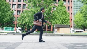 Asian businessman running in the city - Powered by Shutterstock - Get 15% off with code: PIKWIZARD15