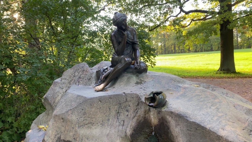 Statue of a girl and water pouring from a jug