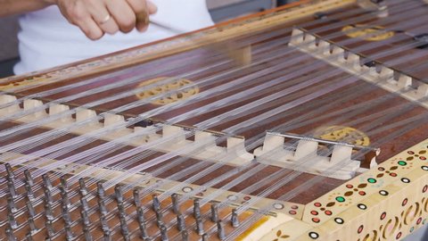 Playing stringed instrument. Hammered dulcimer close up. Leisure and hobby concept. Meditation music. Musician playing hammered dulcimer close-up. Stringed percussion musical instrument sounds good