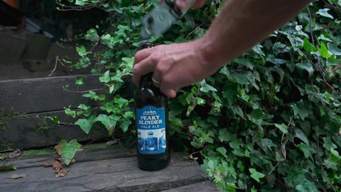 BIRMINGHAM, UK - 2021: Opening a bottle of Peaky Blinder beer