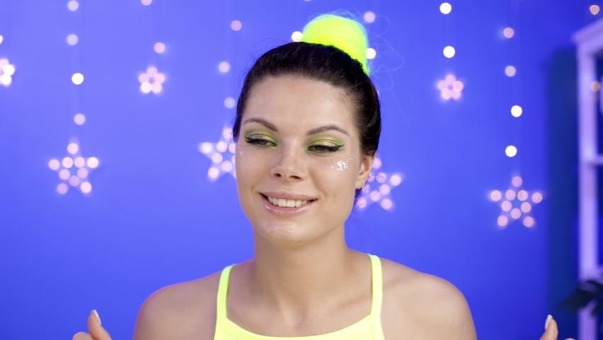 A rich young woman is wearing a tiara over her head.