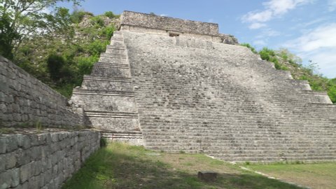 UXMAL, YUCATAN, MEXICO - MAY 2021: The Great Pyramid of Uxmal, an ancient Mayan city located in Yucatan peninsula, panning shot
