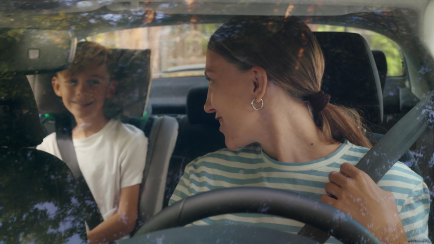 Young family of mother driver and boy ready to move in car to school and using child back seat. Male kid looking outside and joyful woman fastening safety belt. Cheerful adventure and positive emotion Royalty-Free Stock Footage #1079684720