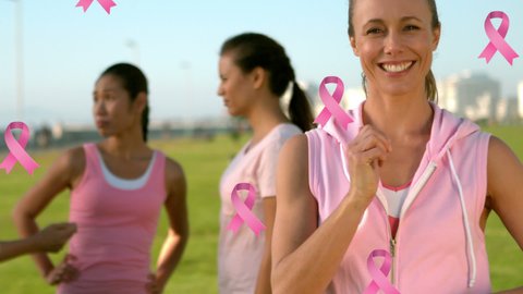 Animation of pink breast cancer ribbons over group of smiling women. breast cancer positive awareness campaign concept digitally generated video.
