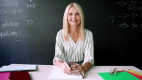 Webcam view of smiling tutor teacher talking having online virtual maths class with schoolchildren sitting at blackboard on videoconference lesson using laptop computer. Distant education concept. - Powered by Shutterstock - Get 15% off with code: PIKWIZARD15