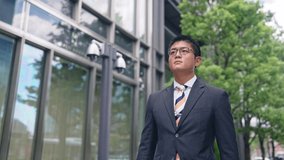 Young asian businessman walking in the city.