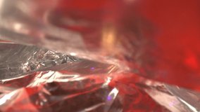 RACK FOCUSING two layers of bright foil. DEFOCUSED front to back, textured colorful foil with predominantly red coloring reflect in the layers of the foil with many contours and texturing. - Powered by Shutterstock - Get 15% off with code: PIKWIZARD15