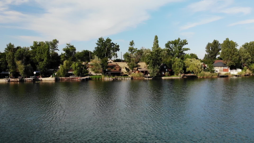 Kavicsos-to Lake, Hungary. Aerial View of Scenic Lakefront, Weekend Getaway From Budapest, Fishing and Residential Houses and Piers, Sliding Drone Shot
