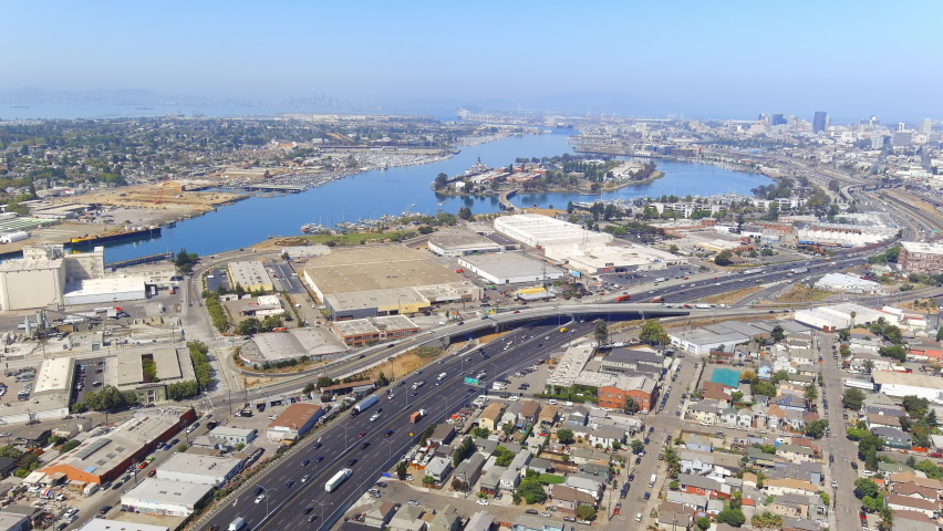 Air log of the Nimitz Freeway and Coast Guard Island Alameda background in Oakland, California.