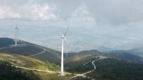 Panoramic view of windmill rotating by wind in mountain landscape. Overhead shot of wind turbine producing clear energy. Green ecological power energy generation. Renewable energy concept, 4k footage