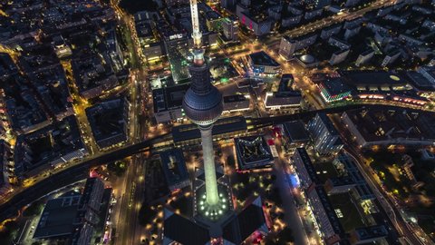 Berlin, Germany - circa 2021: Establishing Aerial View Shot of Berlin, Germany, Alexanderplatz, Mitte, narrow down view, night evening