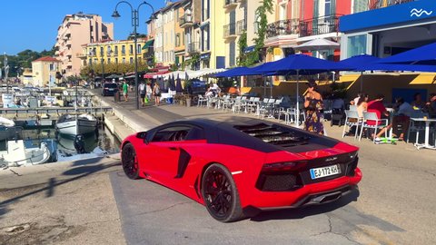 Cassis, France - August 2021 : Lamborghini red luxury car parked on the port of Cassis near Marseille on the French Riviera