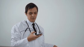 male doctor smiling looking at phone 4k footage