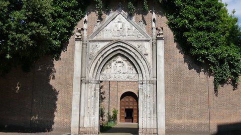 Ravenna Italy JUNE, 5, 2016 Crossing by walking in the arched entrance portal of the Franciscan monastery of Ravenna. Basilica of San Francesco