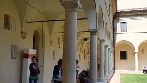 Ravenna Italy JUNE, 5, 2016 Tourists visit the portico of the cloister of the Franciscan monastery of Ravenna