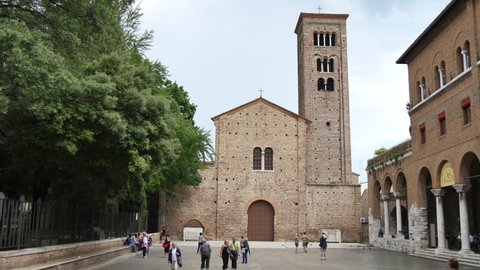 Ravenna Italy JUNE, 5, 2016 Red brick facade of the church Basilica of San Francesco in Ravenna with people strolling in the square