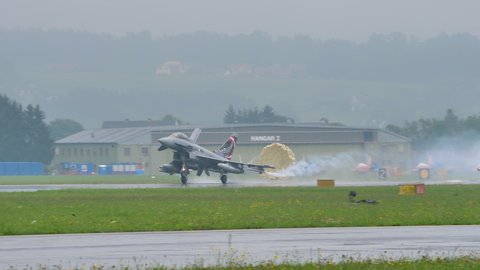 Zeltweg Austria SEPTEMBER, 6, 2019 Air force combat fighter jet plane lands with breaking parachute opened. Eurofighter Typhoon EFA of Austrian Air Force