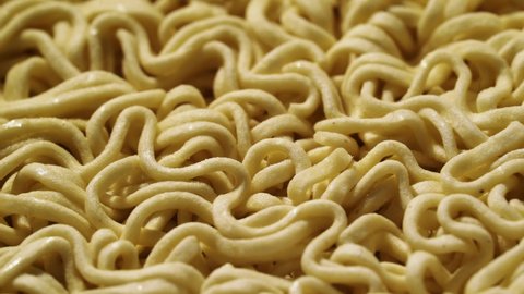 Instant noodles. Cooking, pour boiling water over. Close-up macro shooting. Traditional chinese Asian noodles or pasta. Fast food.