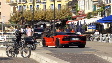 Cassis, France - August 2021 : Lamborghini red luxury car parked on the port of Cassis near Marseille on the French Riviera