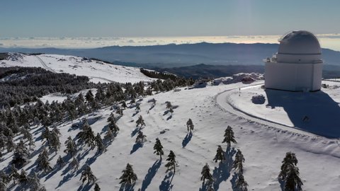 Aerial footage of astronomic observatory of Calar Alto after snowfall in Sierra de los Filabres Almeria Spain