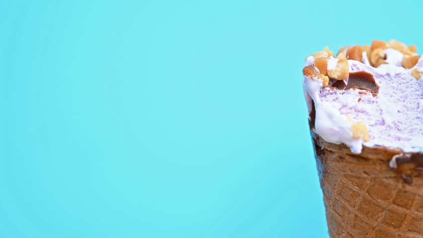 pan view different flavors ice cream cones with bites on blue close up