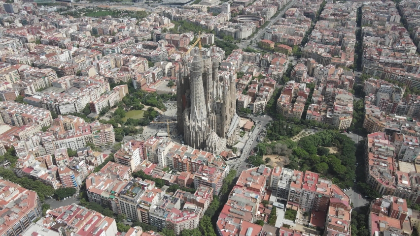 Aerial view of La Sagrada Familia cathedral, over the city of Barcelona, in Spain. Drone video of Sagrada Familia neighborhood in Catalonia, Peninsula Iberica Espana.