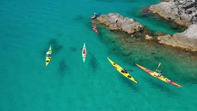 Aerial drone video of women athletes rowing in sports kayak in tropical Caribbean exotic destination with turquoise calm sea