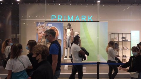 Europe, Italy, Milan September 2021 - Arese Shopping center Il Centro - Primark shop point of sale , people with mask after finish of lockdown due Covid-19 Coronavirus epidemic