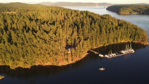 Cinematic 4K aerial drone dolly footage of Orcas Island, Harney Channel, sailboats and yachts anchored near Orcas Village by the Harney Channel in the San Juan Islands in Washington