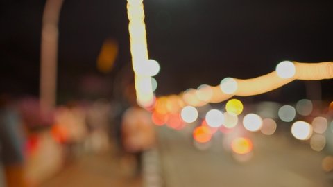 Blurred defocus shot of colorful light bokeh urban city night life with busy or heavy car traffic with car movement and motion. crowded street. Loi Krathong festival