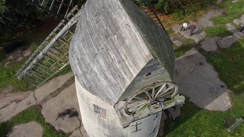 Bidston , United Kingdom (UK) - 09 23 2021: Bidston hill disused rural flour mill restored traditional wooden sail windmill Birkenhead aerial view top down