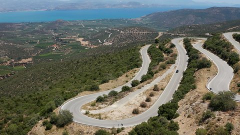 Car Driving On Hairpin Turn By Mountain Pass In Peloponnese Region, Greece. - aerial