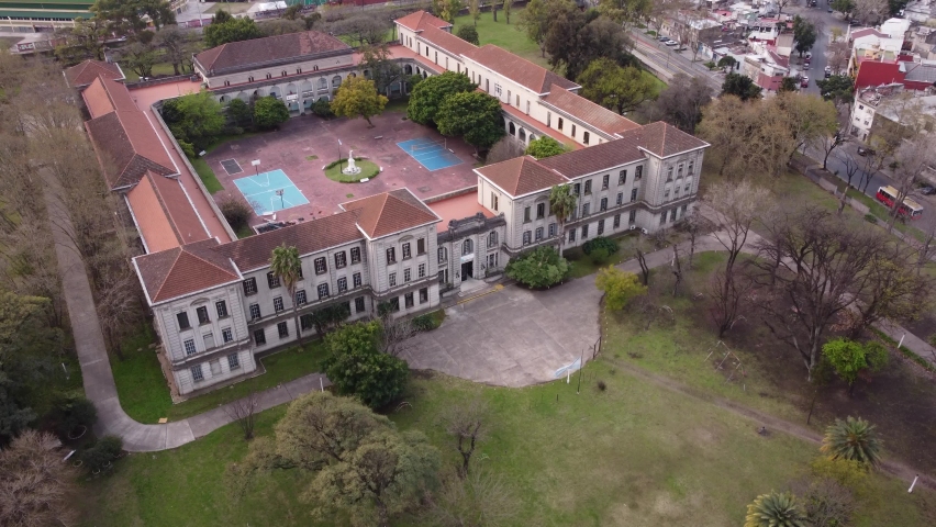 Aerial view showing historic old classic school in Buenos Aires surrounded by green park forest
