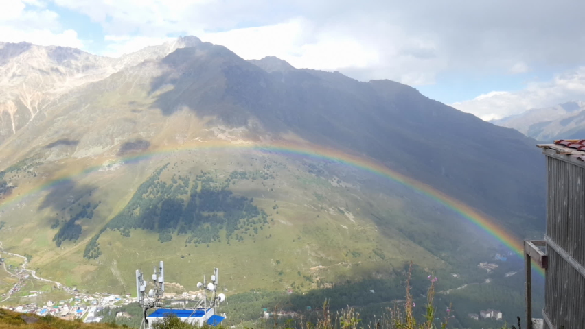 Huge rainbow in the mountains in autumn.