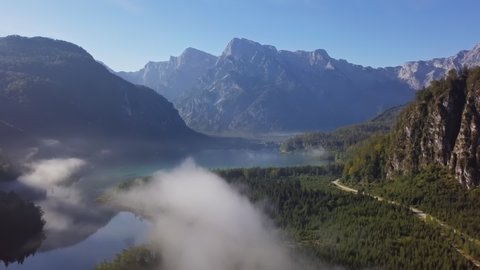 Summer morning light fog aerial view of Lake Alm (Almsee) in Salzkammergut, Austria. 2.5x speeded up from 24 fps.