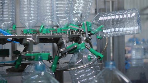 The process of rinsing plastic bottles before they go on tap. Production of drinking water at a food processing plant